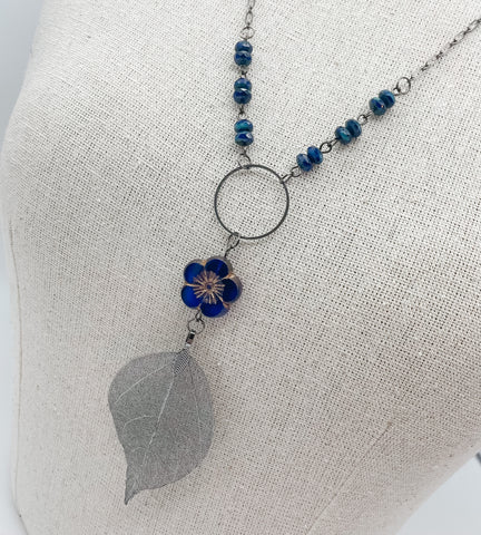 Sapphire Hibiscus Flower & Gun Metal Leaf Necklace